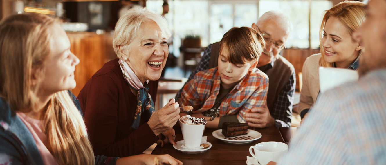 A multi-generational family enjoying ice cream together.
