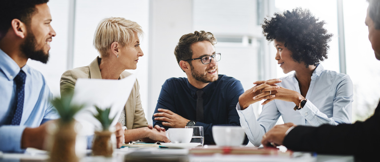 A group of young professionals gathered in a meeting.